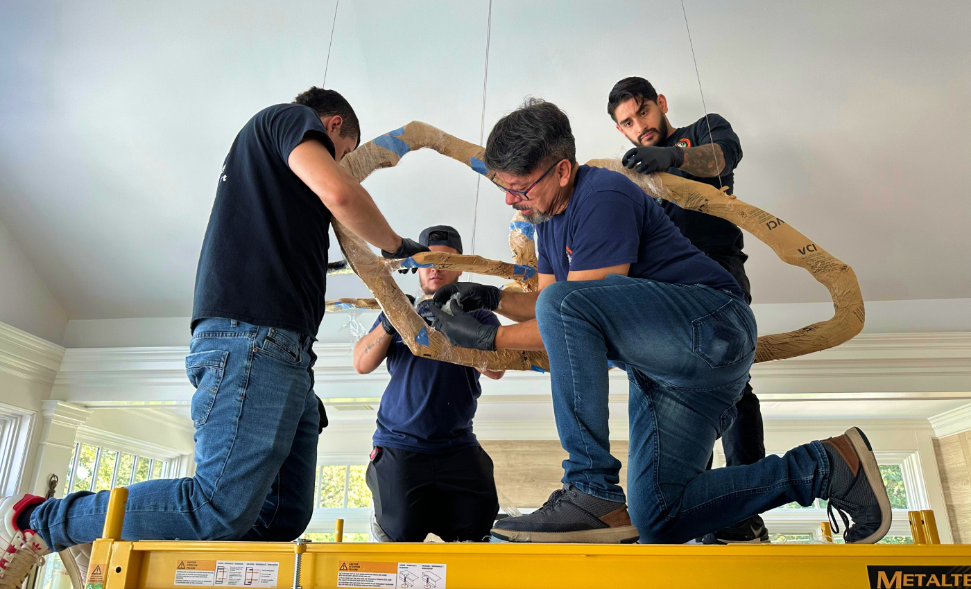 Team handling artwork